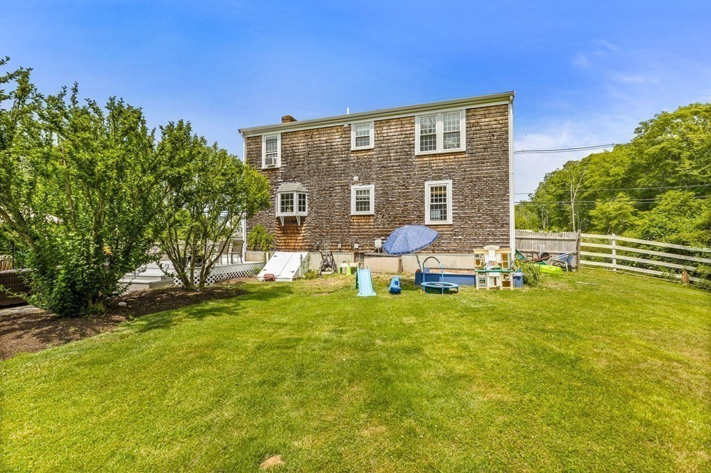 207 Tilden Road Scituate, MA 02066 - Photo 23 of 34 a backyard of a house with table and chairs