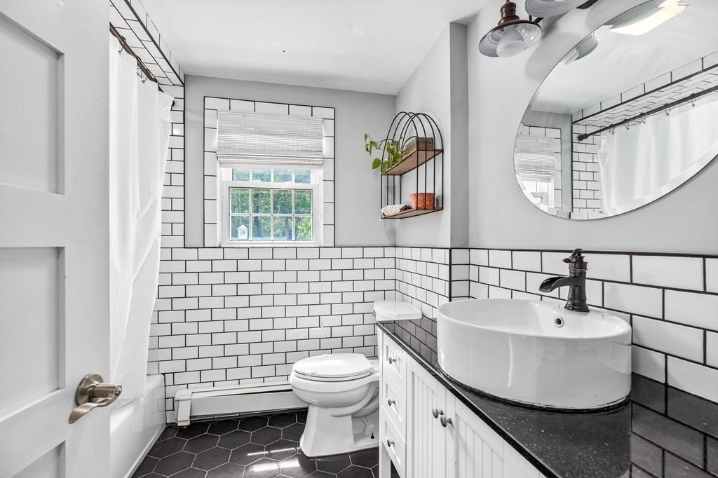 207 Tilden Road Scituate, MA 02066 - Photo 8 of 34 a bathroom with a sink toilet and mirror