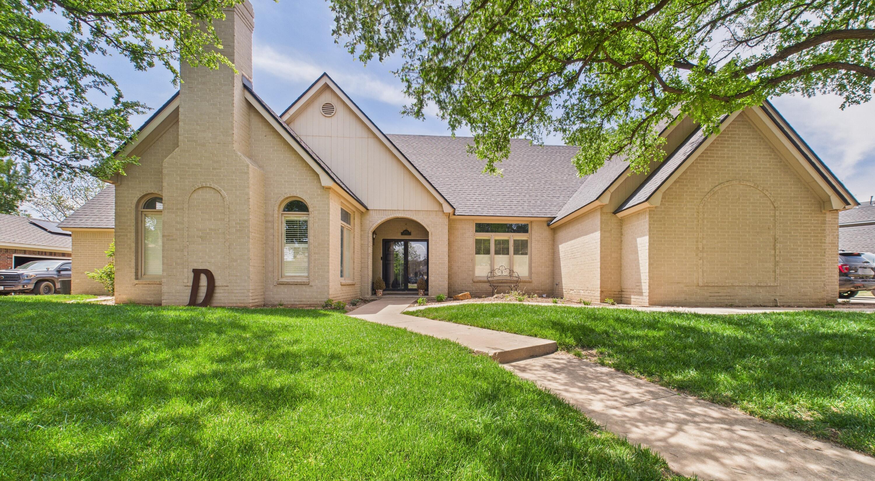 4615 94th Street Lubbock, TX 79424 - Photo 1 of 82 a front view of a house with a yard and garage