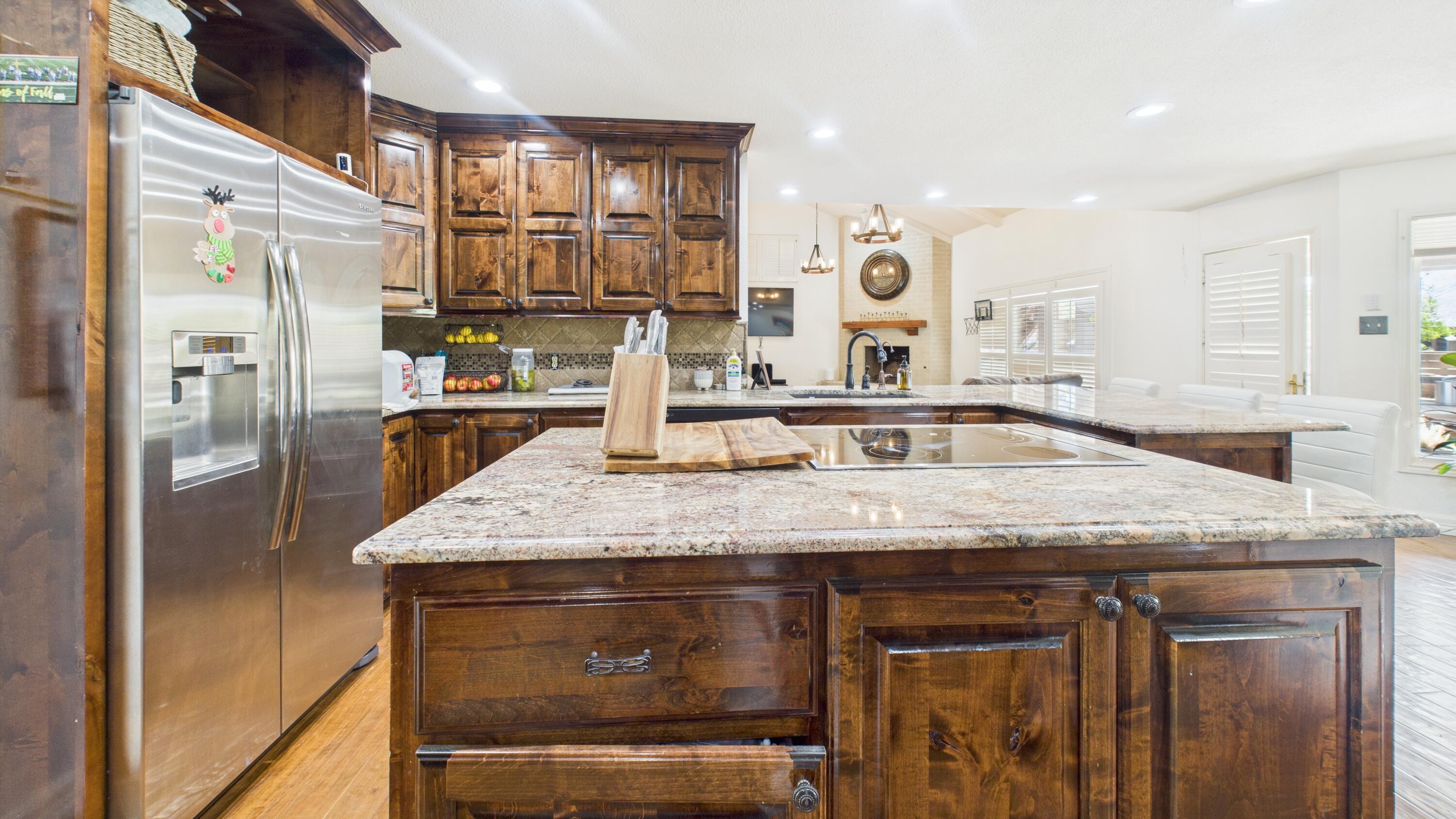 4615 94th Street Lubbock, TX 79424 - Photo 20 of 82 a kitchen with stainless steel appliances granite countertop a sink and a refrigerator