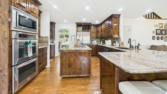 a living room with furniture a fireplace and wooden floor