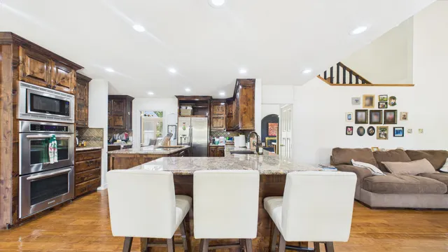 a living room with furniture ceiling fan and a window