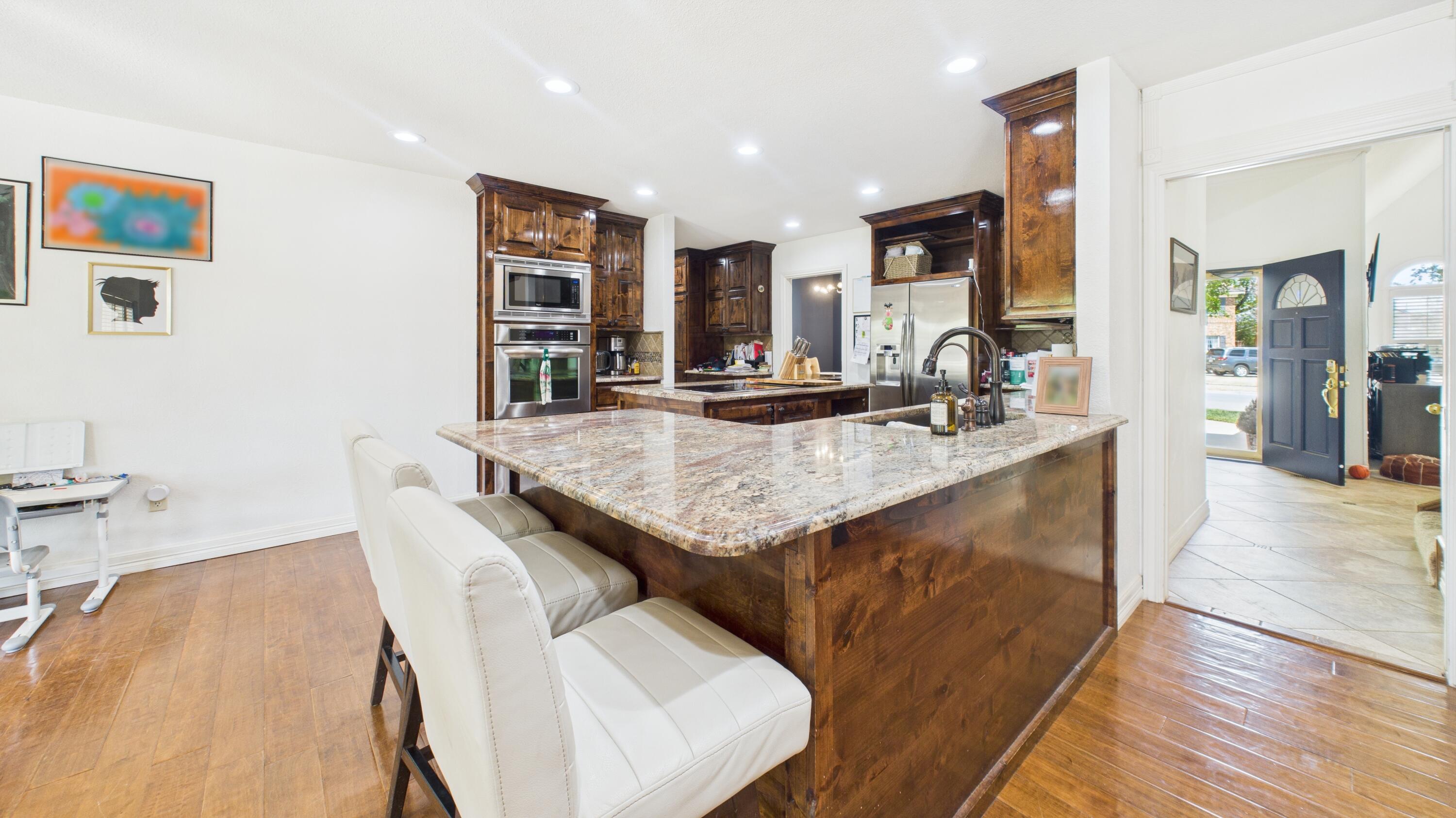 4615 94th Street Lubbock, TX 79424 - Photo 23 of 82 a view of kitchen island a sink and living room view
