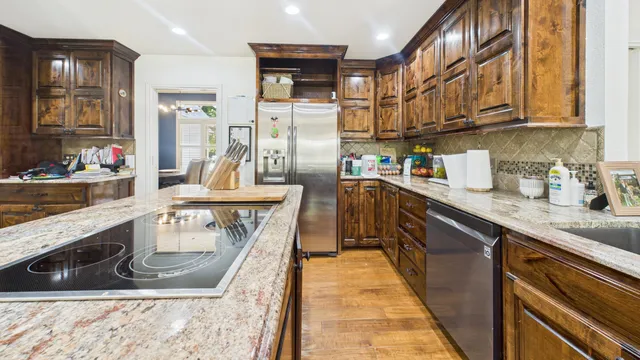 a bathroom with a granite countertop toilet sink and mirror