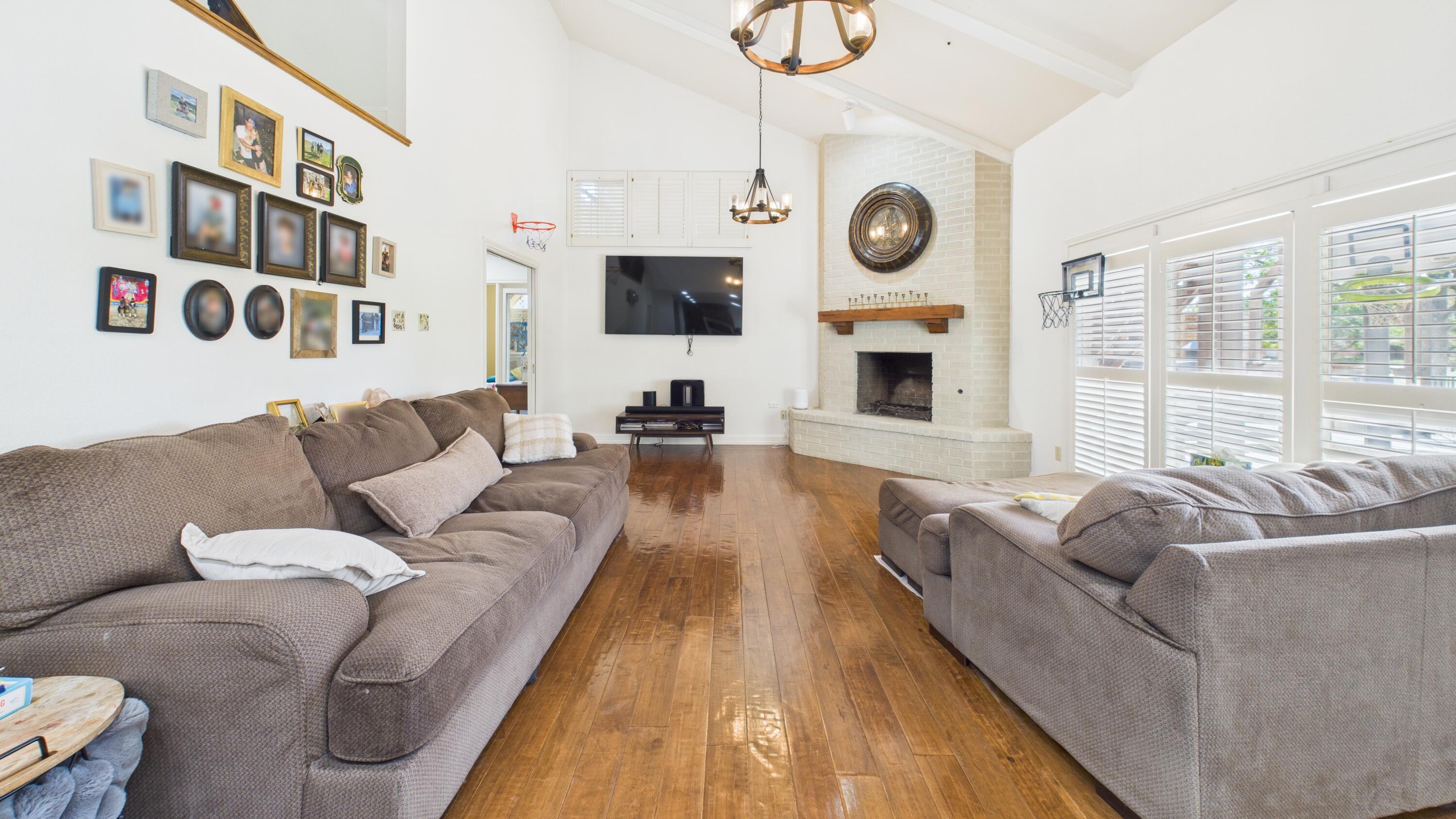 4615 94th Street Lubbock, TX 79424 - Photo 29 of 82 a living room with fireplace furniture and a flat screen tv
