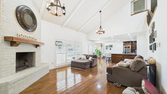 a view of staircase with lots of frames on wall and a window