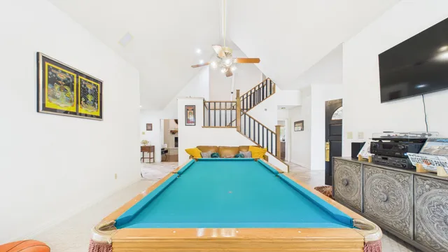 a view of a patio with table and chairs and a barbeque with wooden fence