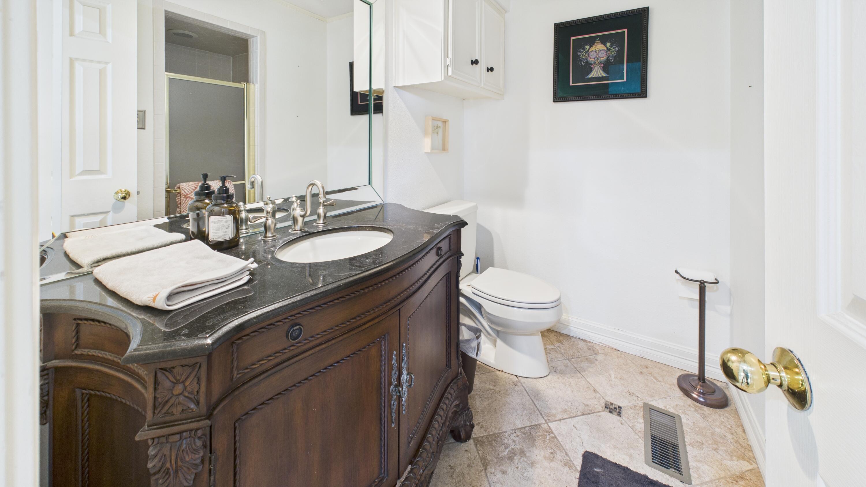 4615 94th Street Lubbock, TX 79424 - Photo 48 of 82 a bathroom with a sink toilet and mirror