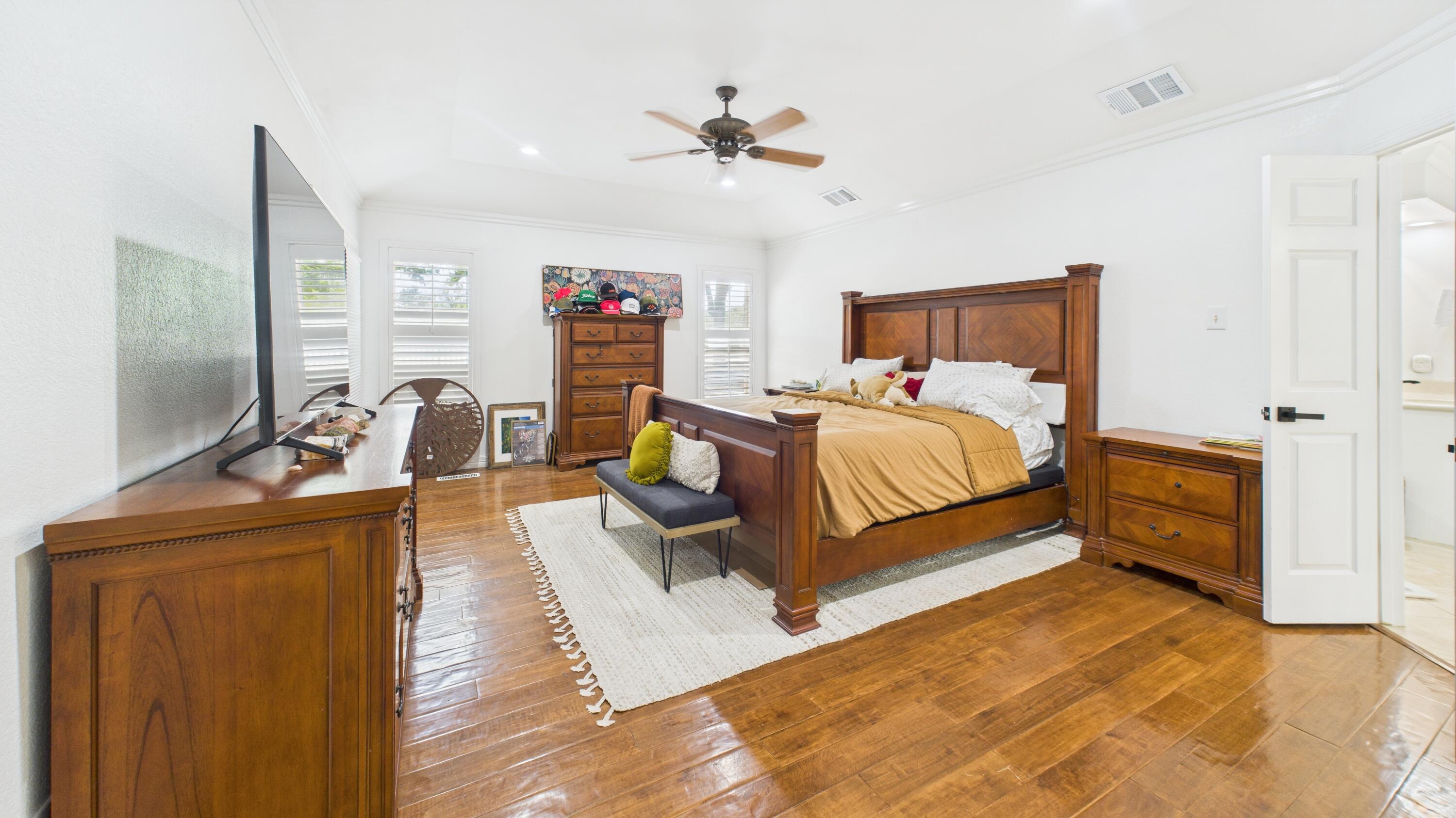 4615 94th Street Lubbock, TX 79424 - Photo 53 of 82 a bedroom with a bed and a flat tv screen on the dresser