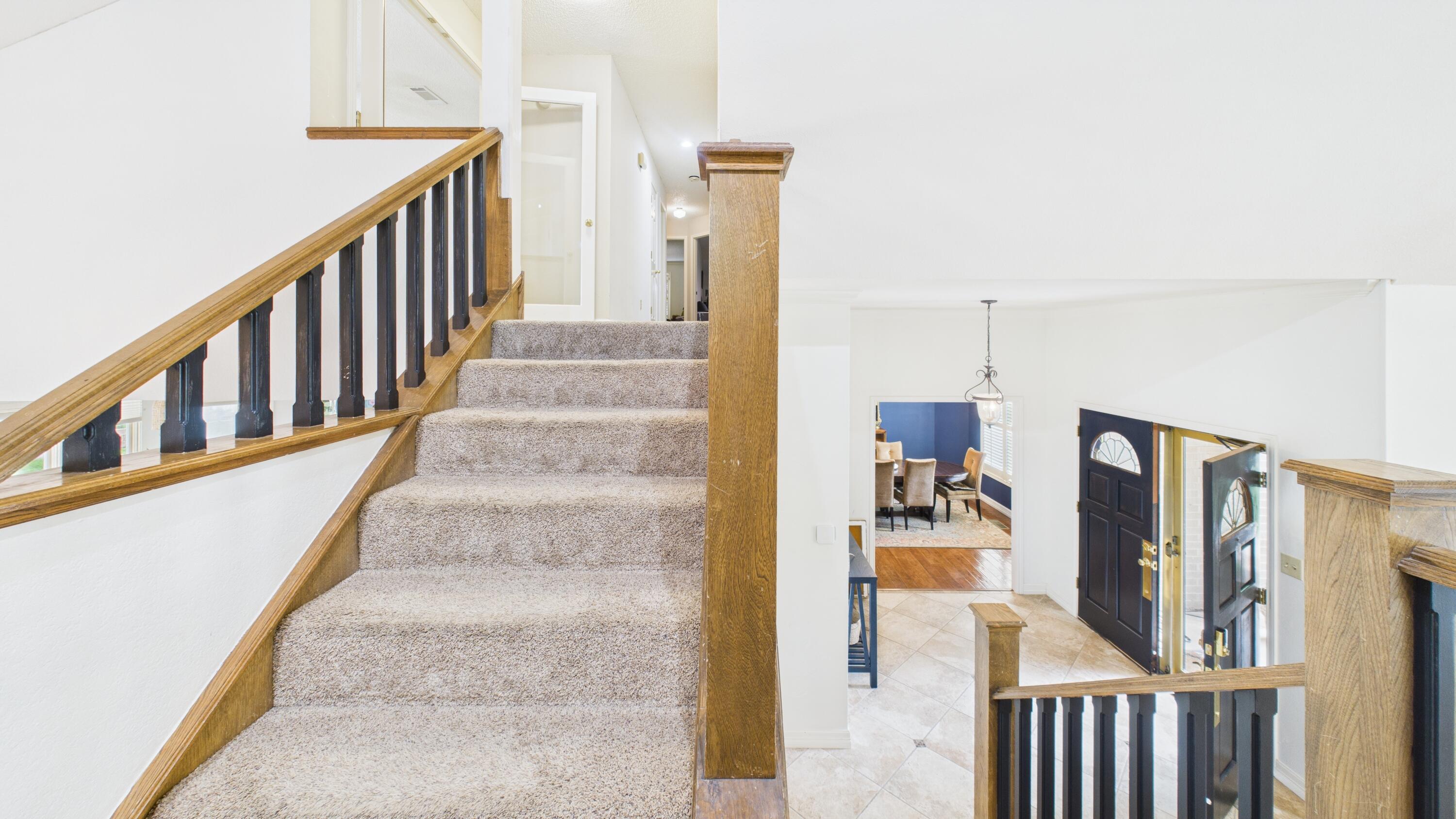 4615 94th Street Lubbock, TX 79424 - Photo 60 of 82 a view of staircase with lots of frames on wall and a window