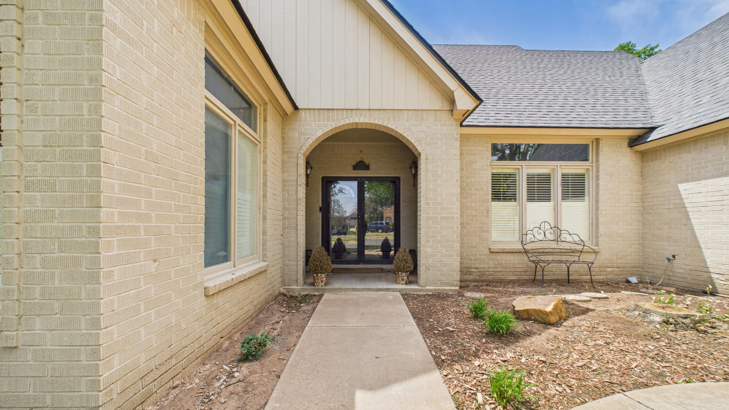 4615 94th Street Lubbock, TX 79424 - Photo 9 of 82 a front view of a house with a garden