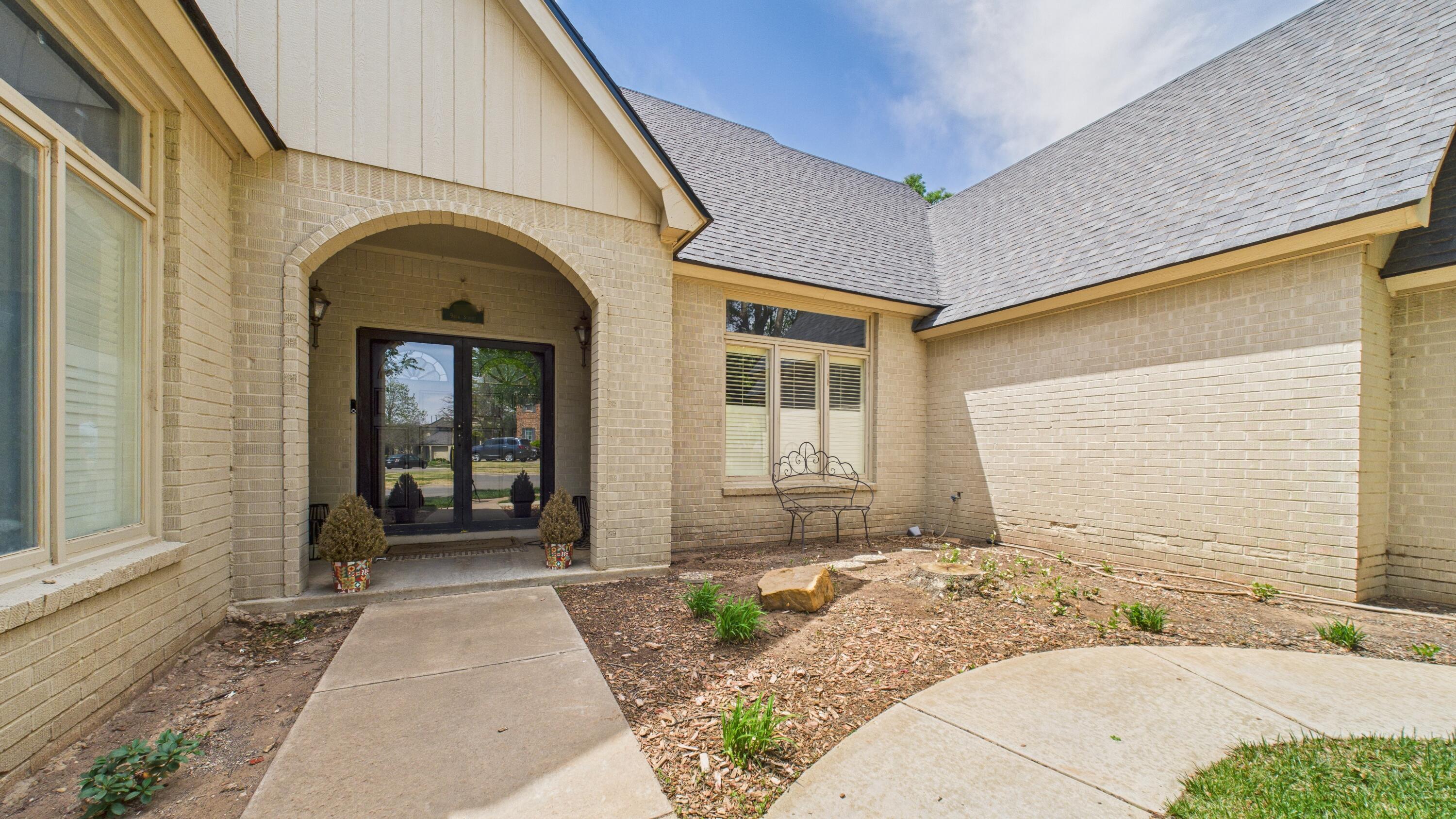 4615 94th Street Lubbock, TX 79424 - Photo 10 of 82 a front view of a house with a yard