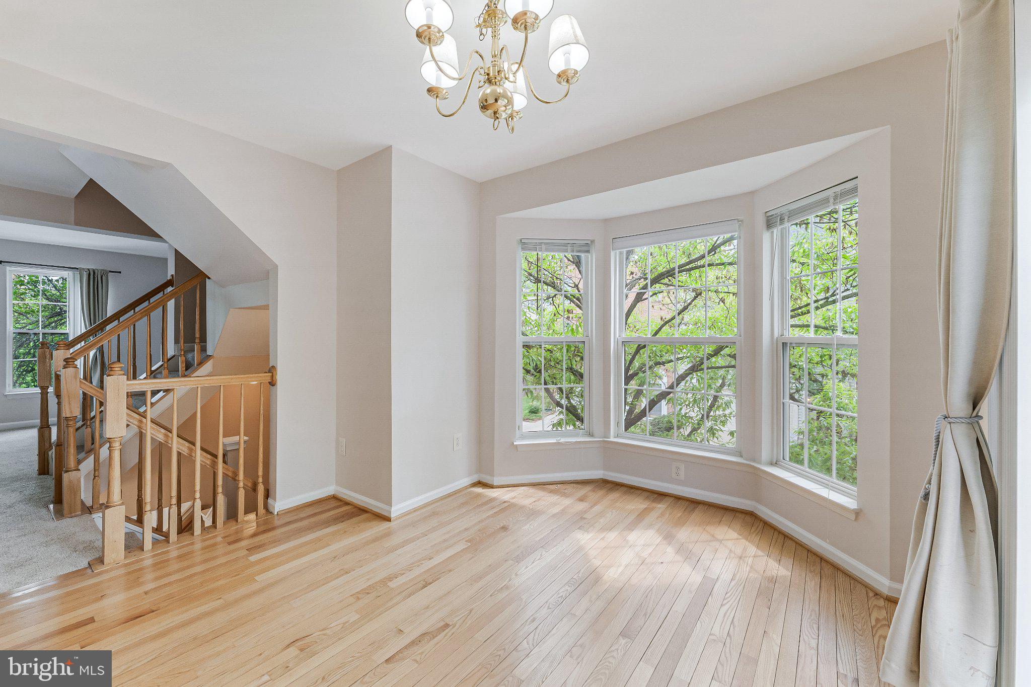 6414 Lureta Ann Lane Springfield, VA 22150 - Photo 11 of 44 a view of an empty room with wooden floor and a window