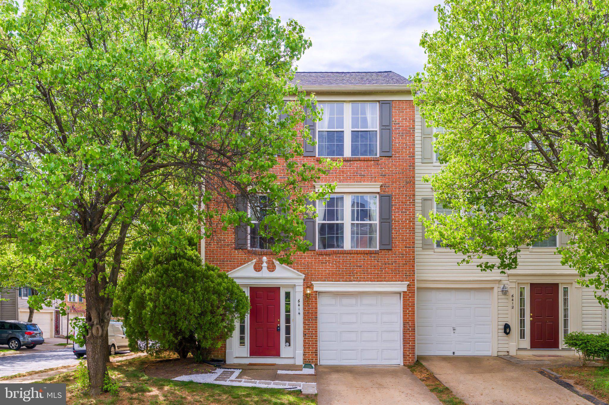 6414 Lureta Ann Lane Springfield, VA 22150 - Photo 2 of 44 a front view of a house with a yard and garage