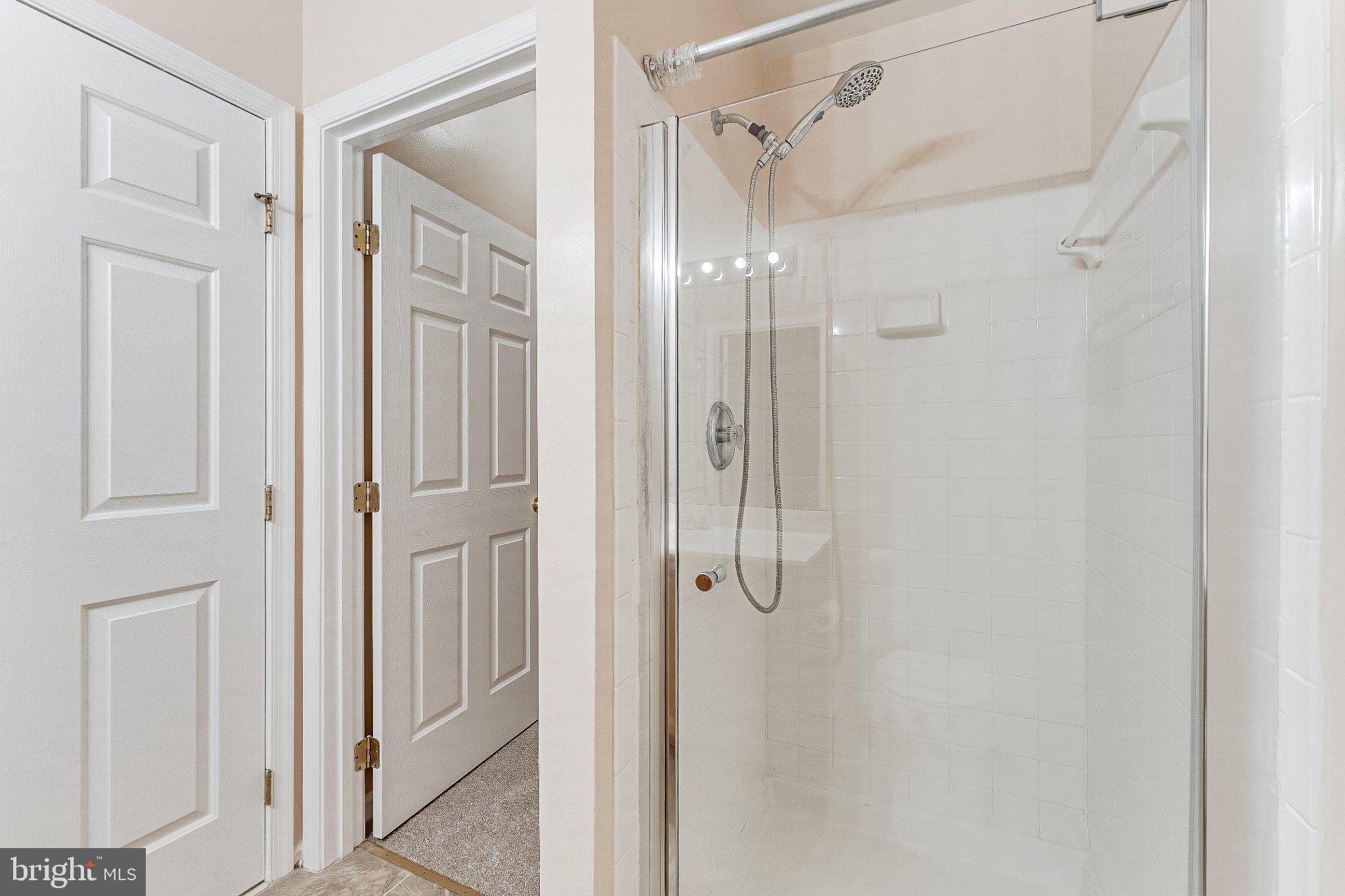 6414 Lureta Ann Lane Springfield, VA 22150 - Photo 22 of 44 a bathroom with a glass shower door