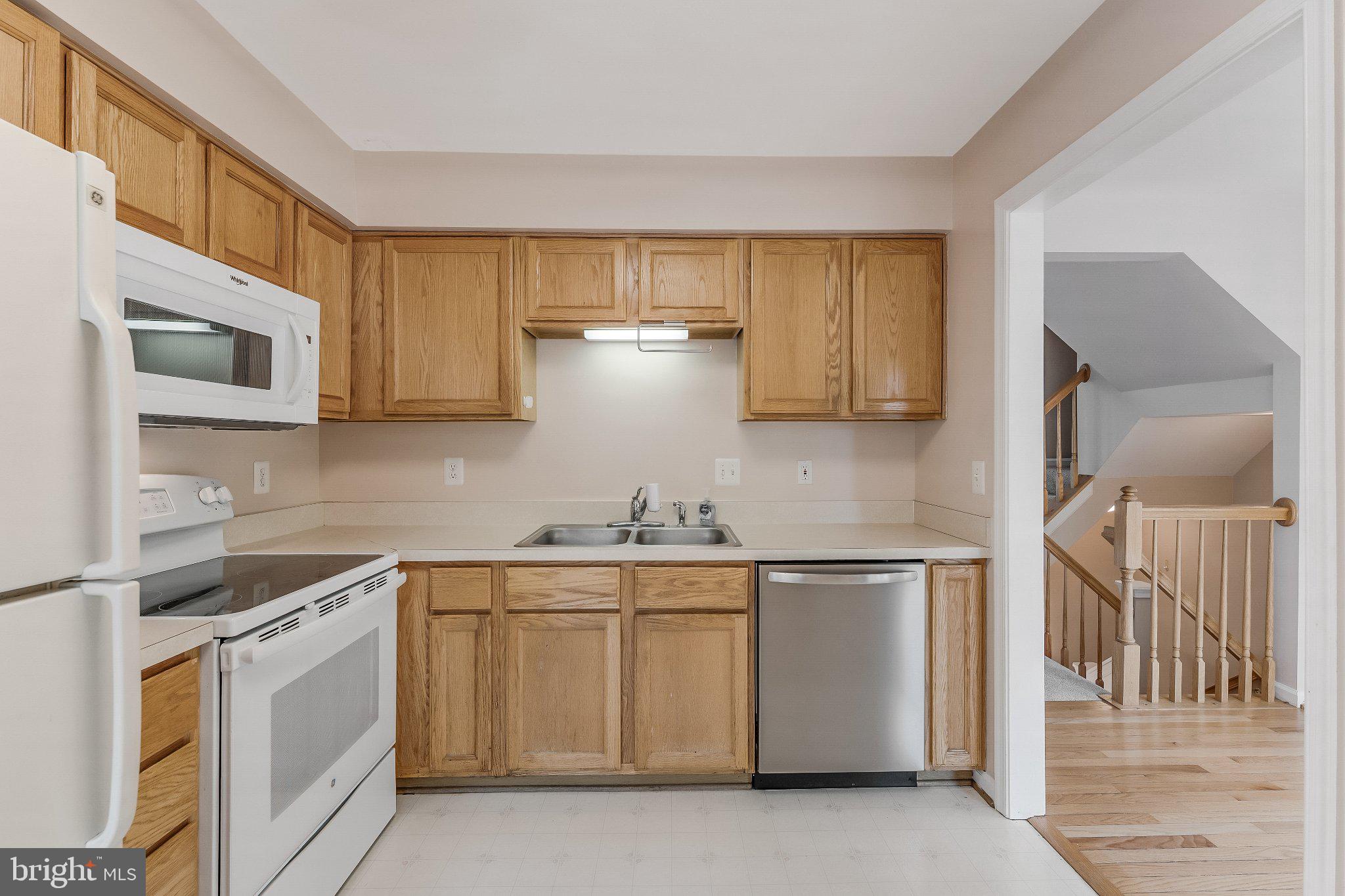 6414 Lureta Ann Lane Springfield, VA 22150 - Photo 5 of 44 a kitchen with stainless steel appliances granite countertop a stove a sink and a microwave