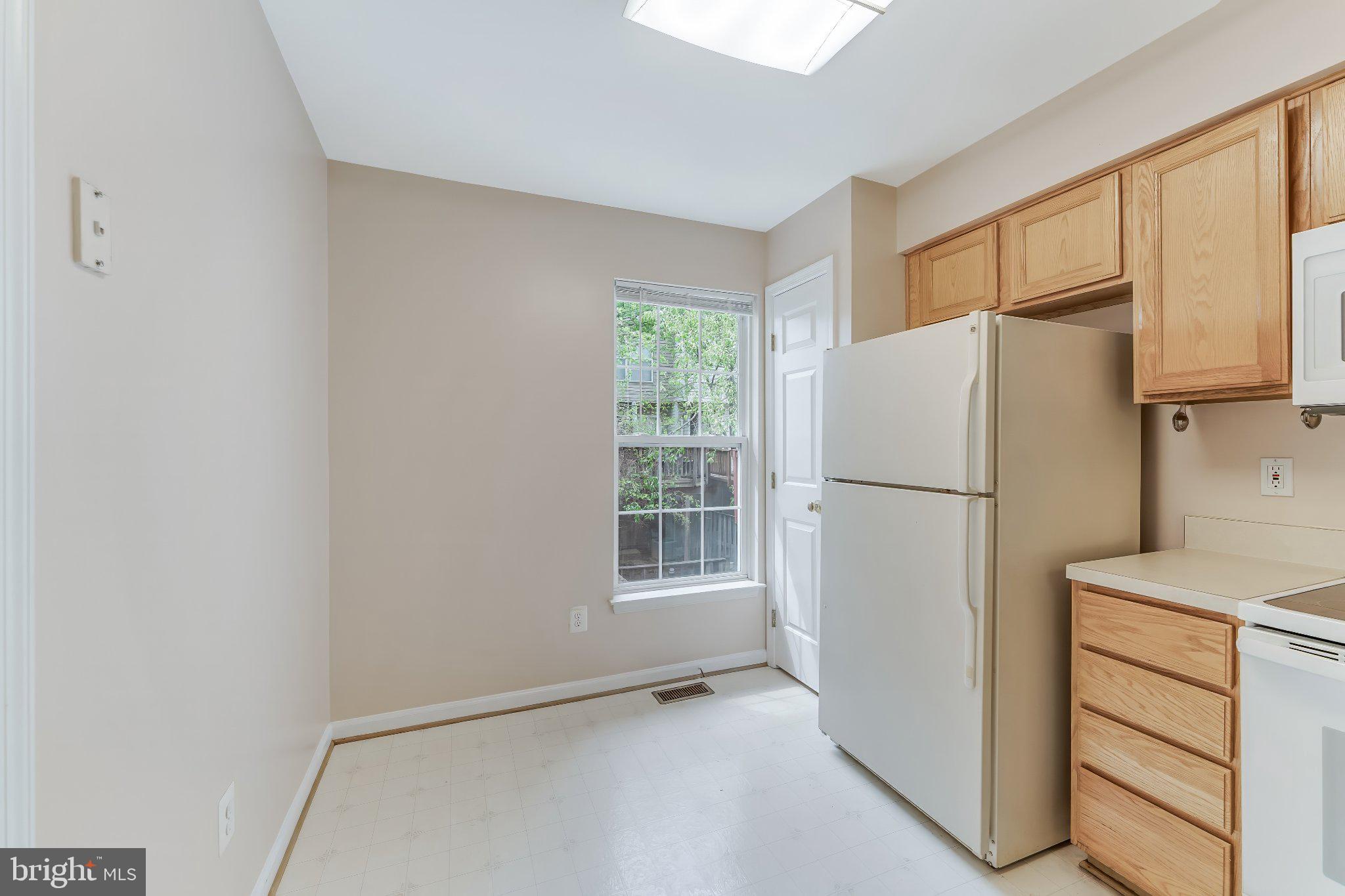 6414 Lureta Ann Lane Springfield, VA 22150 - Photo 9 of 44 a white refrigerator freezer and a stove sitting inside of a kitchen