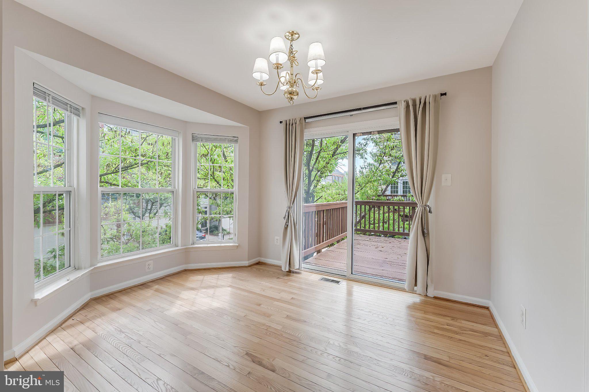6414 Lureta Ann Lane Springfield, VA 22150 - Photo 10 of 44 a view of an empty room with wooden floor and a window