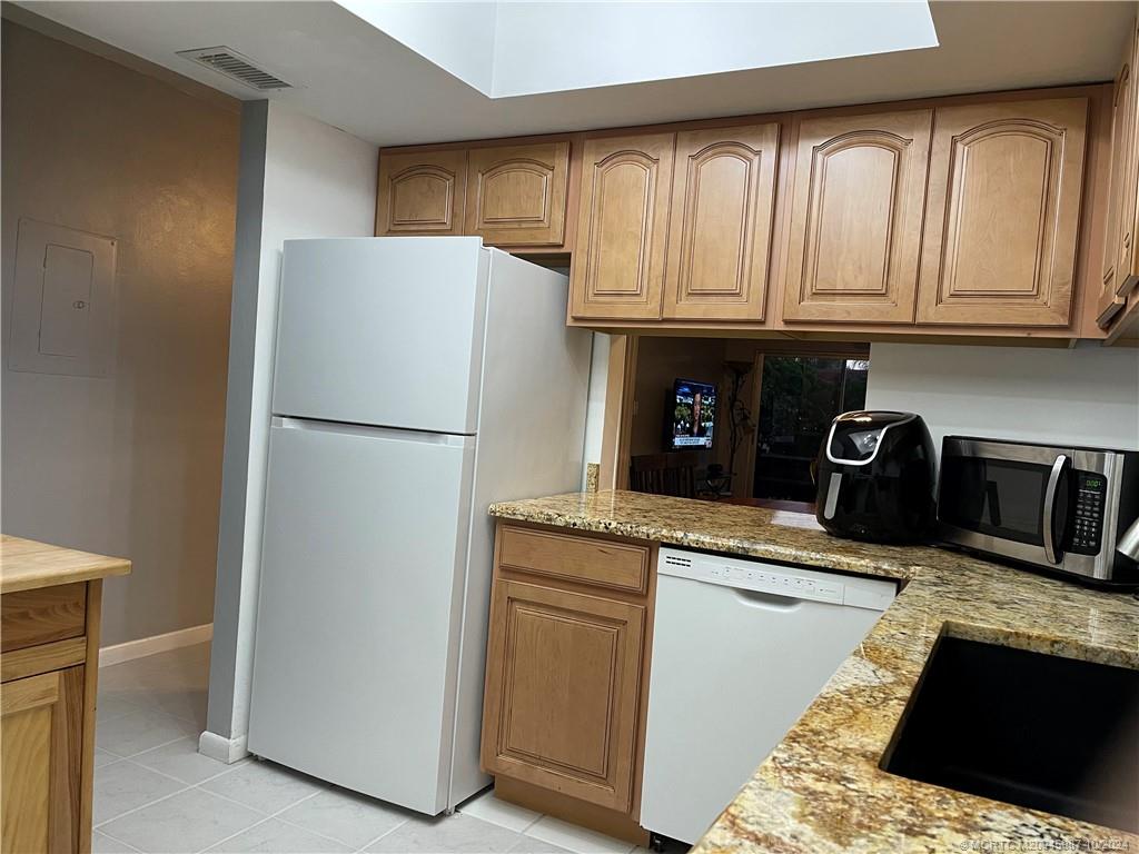 1900 South Kanner Highway, Unit 9202 Stuart, FL 34994 - Photo 15 of 55 a kitchen with stainless steel appliances granite countertop a refrigerator a stove and a sink