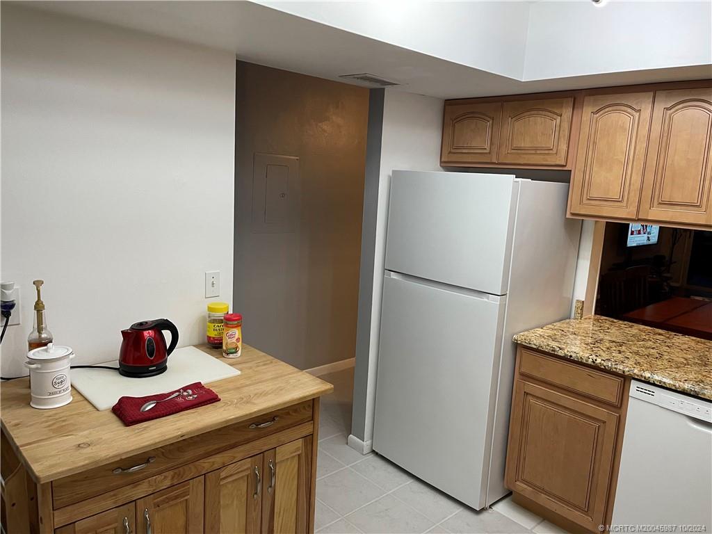 1900 South Kanner Highway, Unit 9202 Stuart, FL 34994 - Photo 16 of 55 a kitchen with a refrigerator and a sink