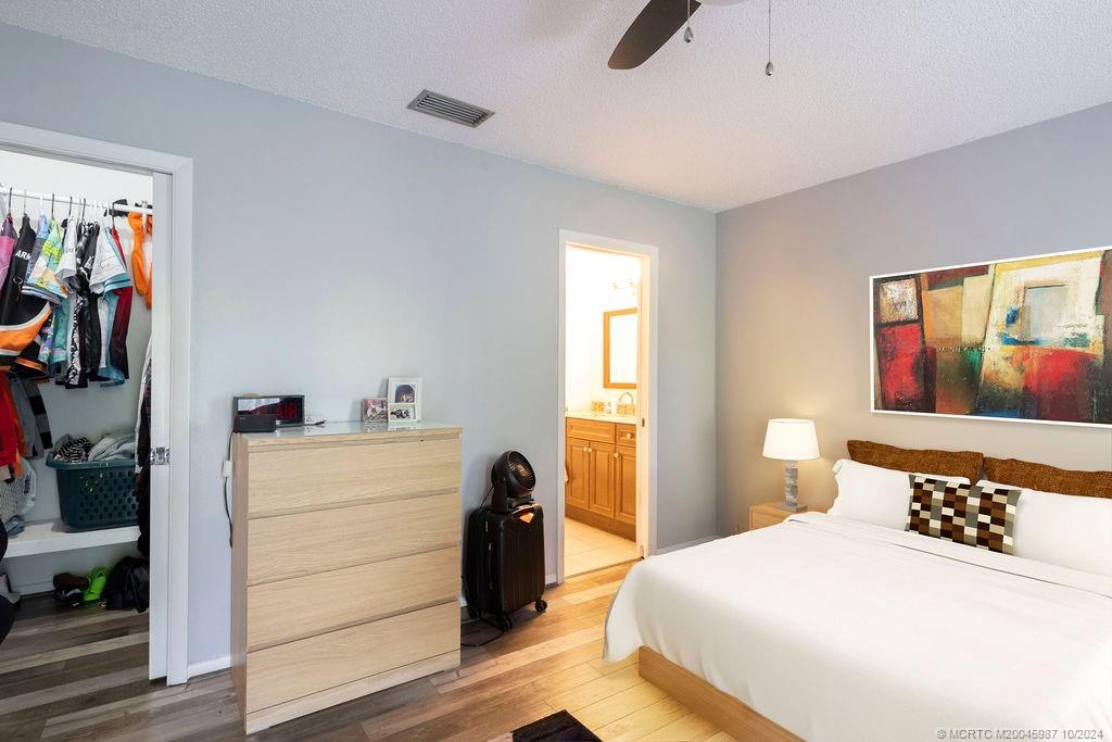 1900 South Kanner Highway, Unit 9202 Stuart, FL 34994 - Photo 34 of 55 a bedroom with a bed and a painting on the wall