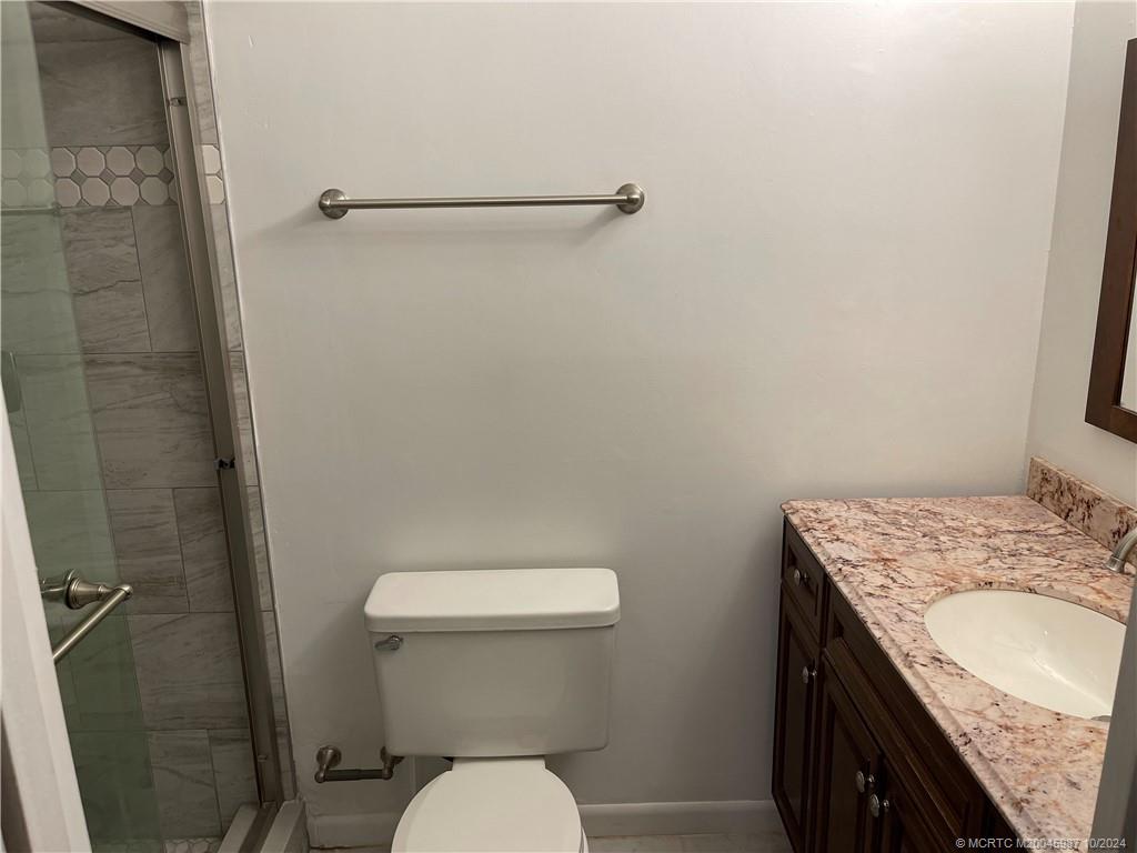 1900 South Kanner Highway, Unit 9202 Stuart, FL 34994 - Photo 36 of 55 a bathroom with a granite countertop toilet and a sink