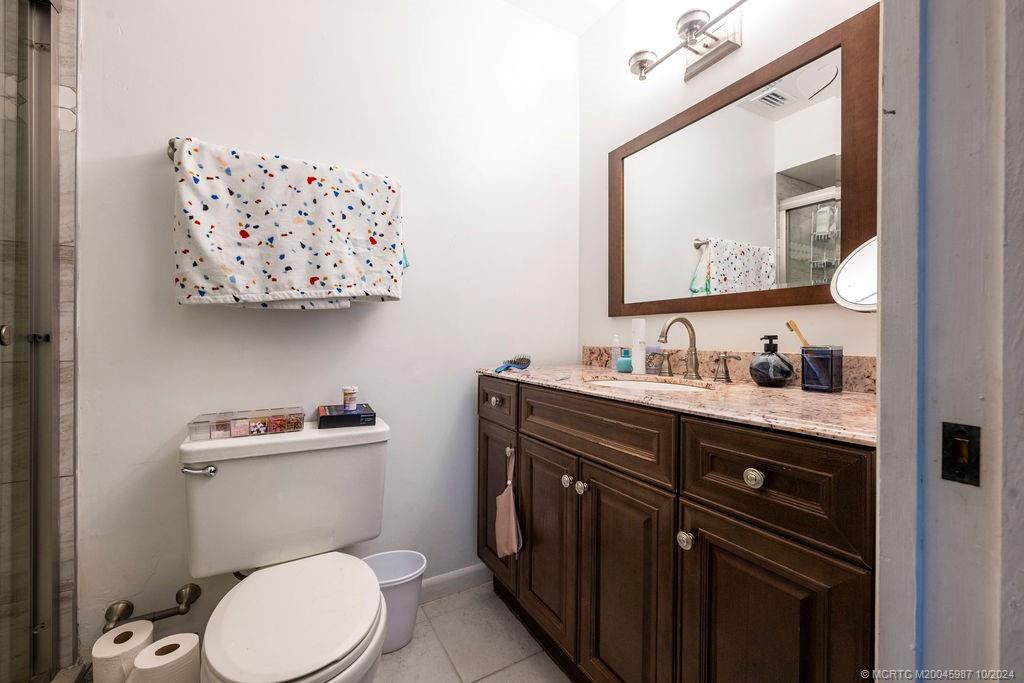 1900 South Kanner Highway, Unit 9202 Stuart, FL 34994 - Photo 38 of 55 a bathroom with a toilet a sink and mirror