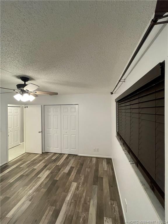 1900 South Kanner Highway, Unit 9202 Stuart, FL 34994 - Photo 40 of 55 a view of a livingroom with wooden floor and a ceiling fan