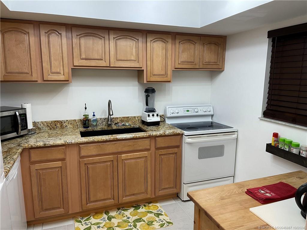 1900 South Kanner Highway, Unit 9202 Stuart, FL 34994 - Photo 10 of 55 a kitchen with stainless steel appliances granite countertop a sink stove and cabinets