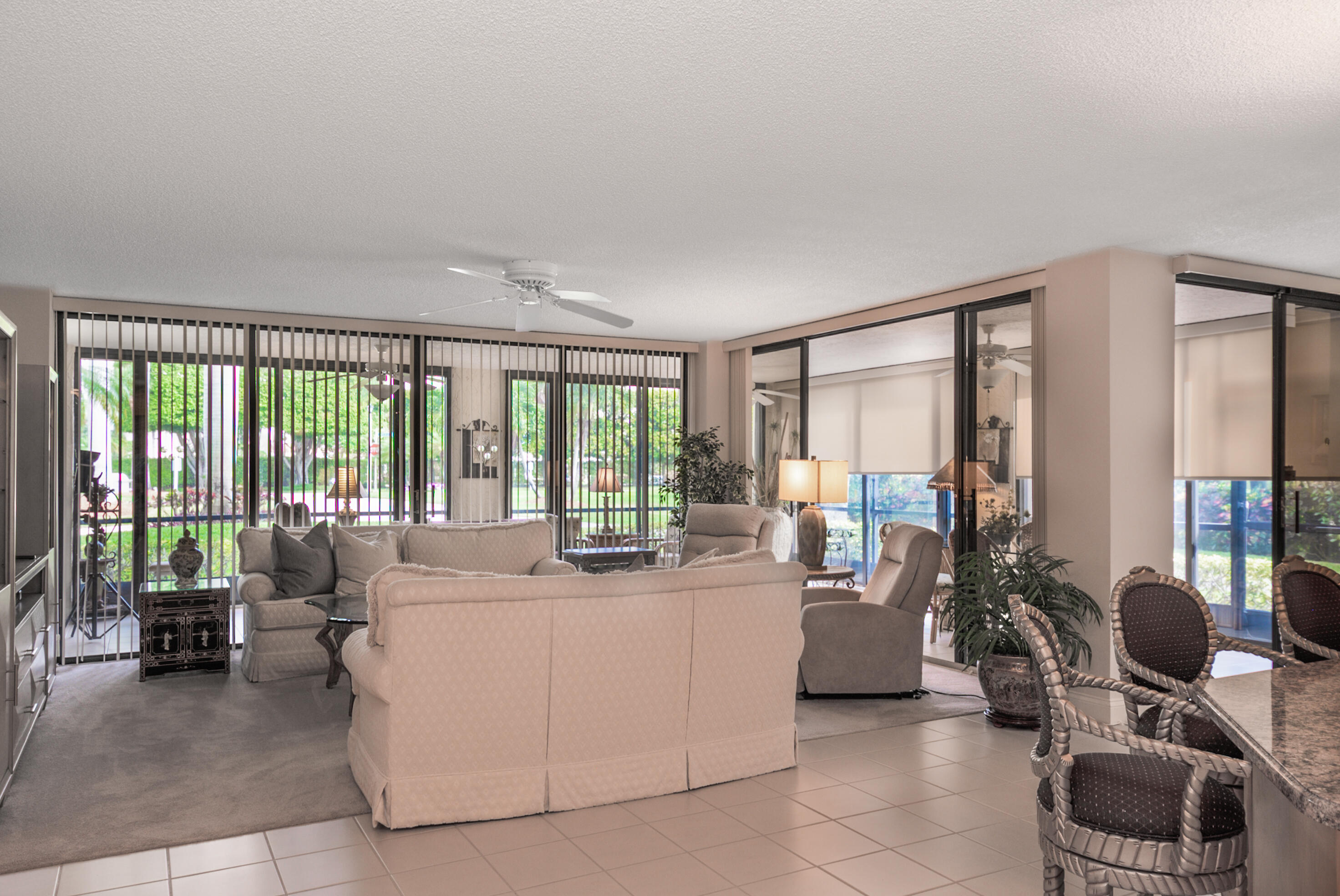 7564 Regency Lake Drive, Unit A101 Boca Raton, FL 33433 - Photo 22 of 33 Living Room & Glassed-in Terrace