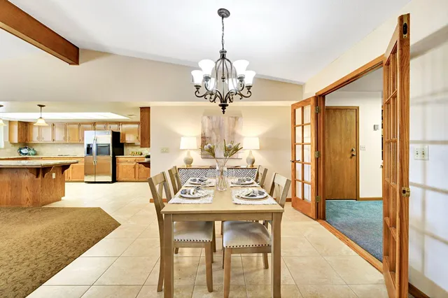 a kitchen with stainless steel appliances granite countertop a sink and a refrigerator