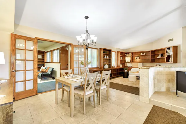 a view of a kitchen with kitchen island a sink stainless steel appliances and cabinets