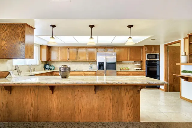 a large kitchen with kitchen island granite countertop lots of counter top space