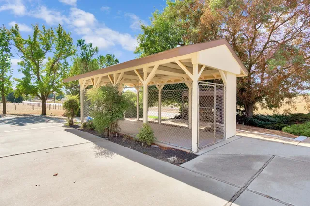 a view of a patio with couches table and chairs and potted plants