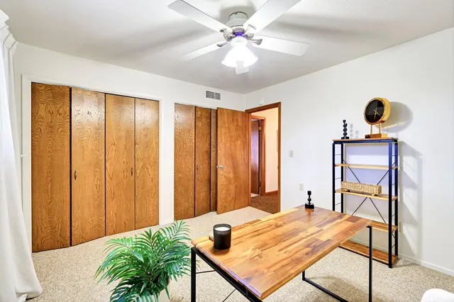 a view of a patio with table and chairs and potted plants