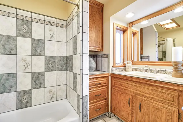 an aerial view of a house with a yard and a large tree