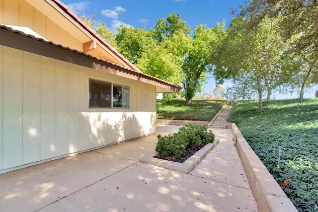 an aerial view of a house with a yard and garden