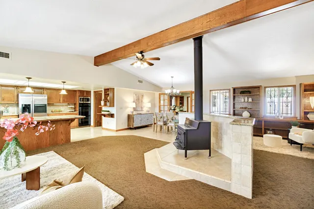 a living room with furniture and a chandelier
