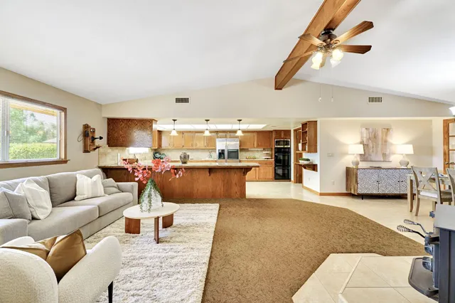 a living room with furniture and a kitchen view