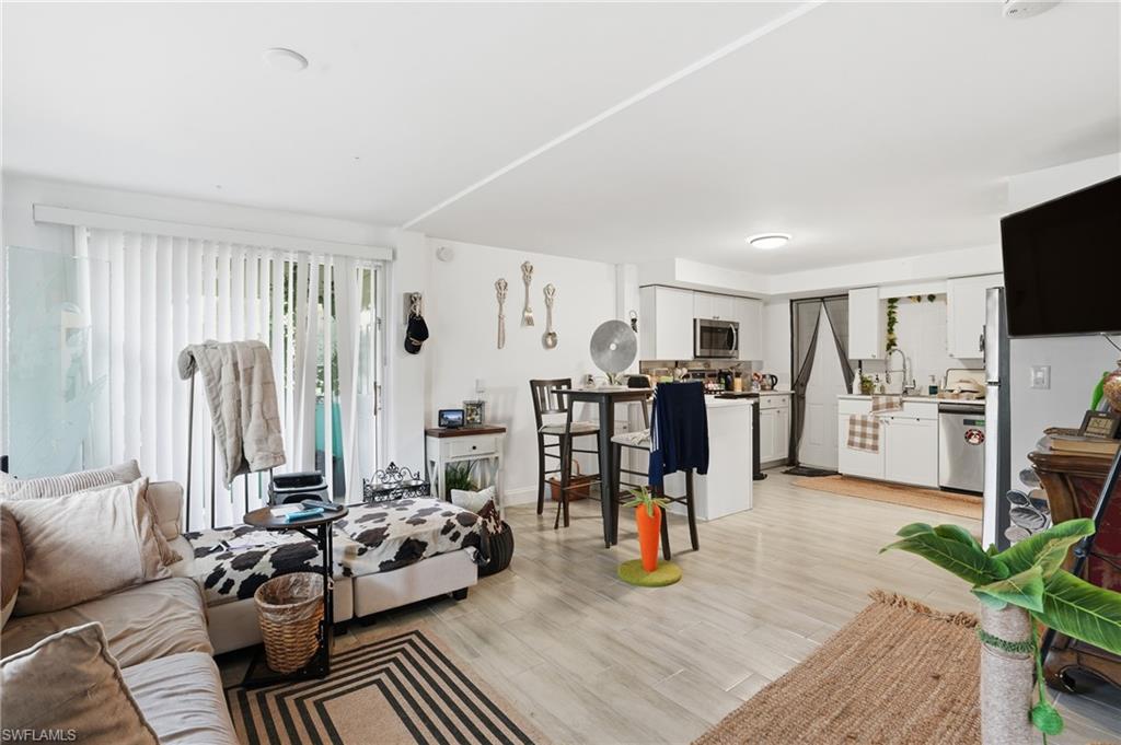 5474 Oak Ridge Avenue Fort Myers Beach, FL 33931 - Photo 11 of 50 a living room with furniture and a flat screen tv