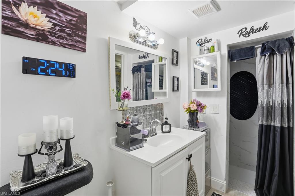 5474 Oak Ridge Avenue Fort Myers Beach, FL 33931 - Photo 16 of 50 a bathroom with a sink and a mirror