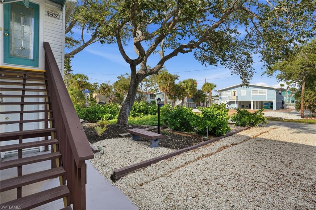 5474 Oak Ridge Avenue Fort Myers Beach, FL 33931 - Photo 18 of 50 a view of a backyard with a tree