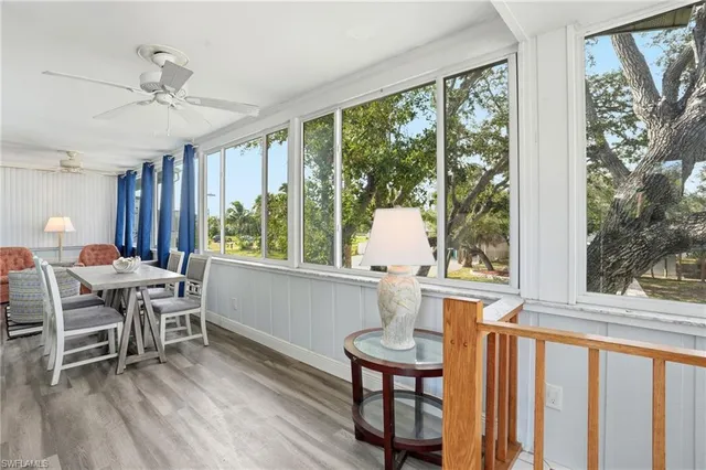 a living room with furniture and large windows