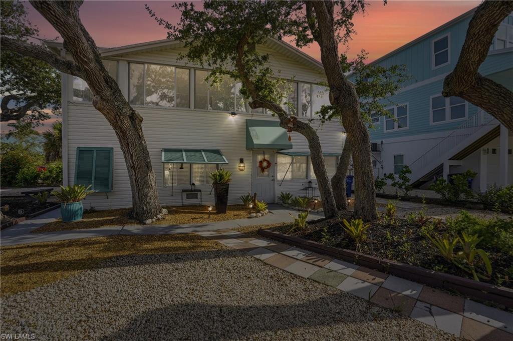 5474 Oak Ridge Avenue Fort Myers Beach, FL 33931 - Photo 2 of 50 a front view of a house with garden