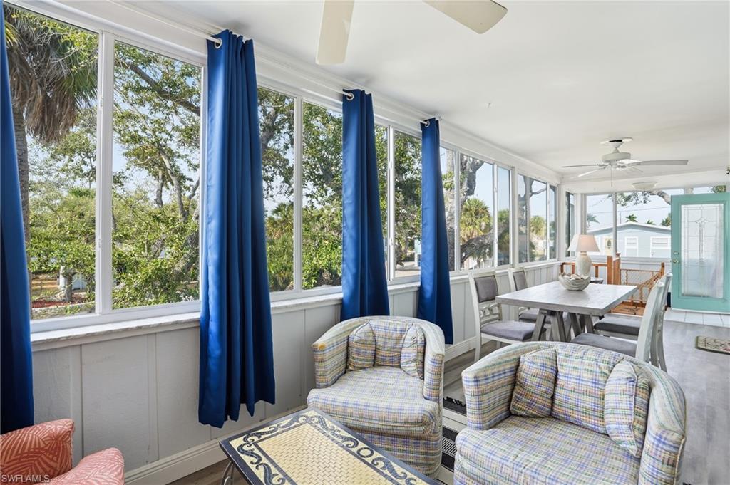 5474 Oak Ridge Avenue Fort Myers Beach, FL 33931 - Photo 21 of 50 a living room with furniture and large windows