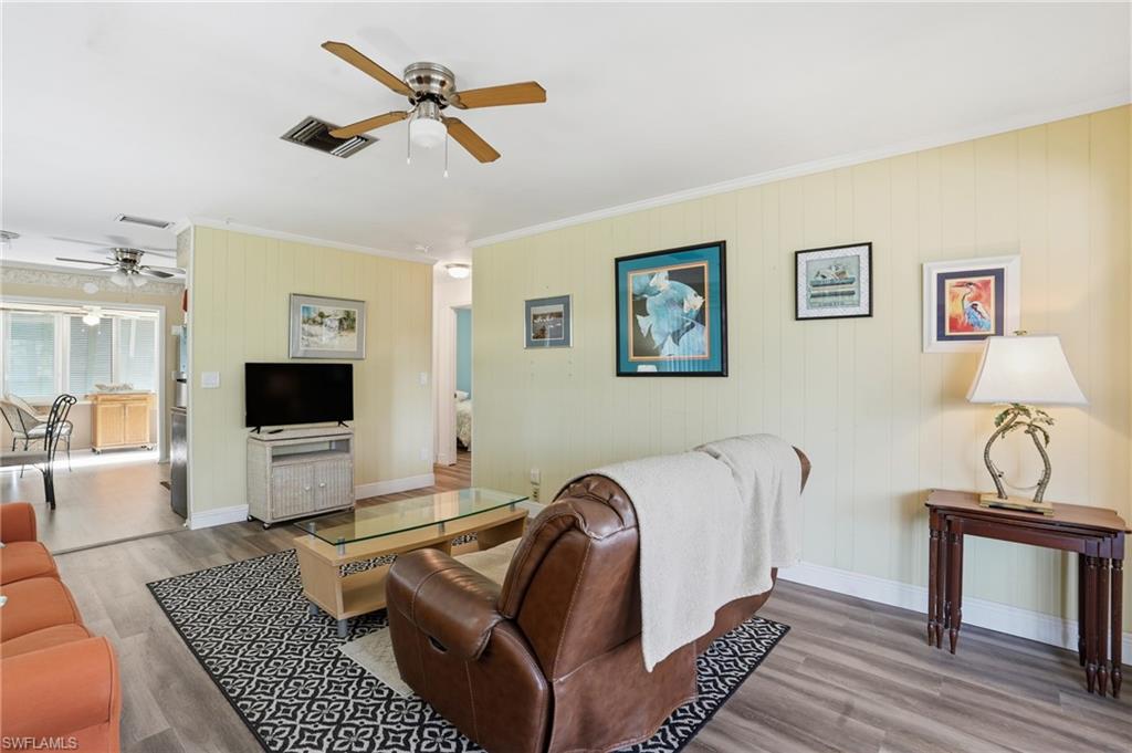 5474 Oak Ridge Avenue Fort Myers Beach, FL 33931 - Photo 24 of 50 a living room with furniture a ceiling fan and a rug