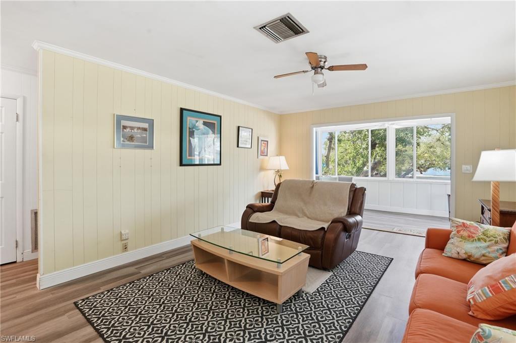 5474 Oak Ridge Avenue Fort Myers Beach, FL 33931 - Photo 27 of 50 a living room with furniture and a window