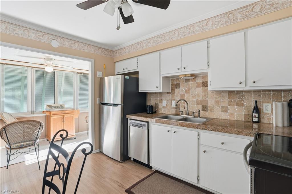 5474 Oak Ridge Avenue Fort Myers Beach, FL 33931 - Photo 28 of 50 a kitchen with appliances a sink and cabinets
