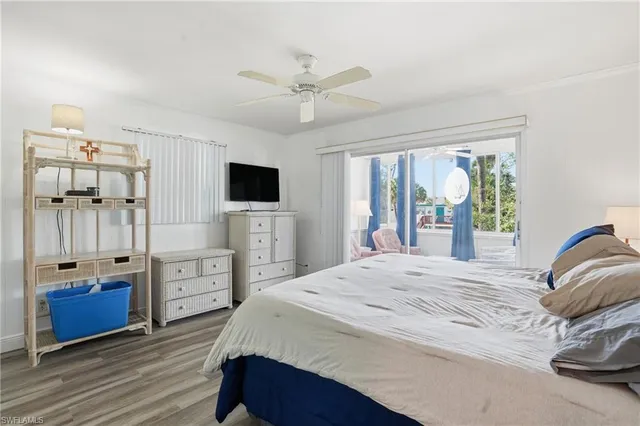 a bedroom with a bed a large window and a balcony