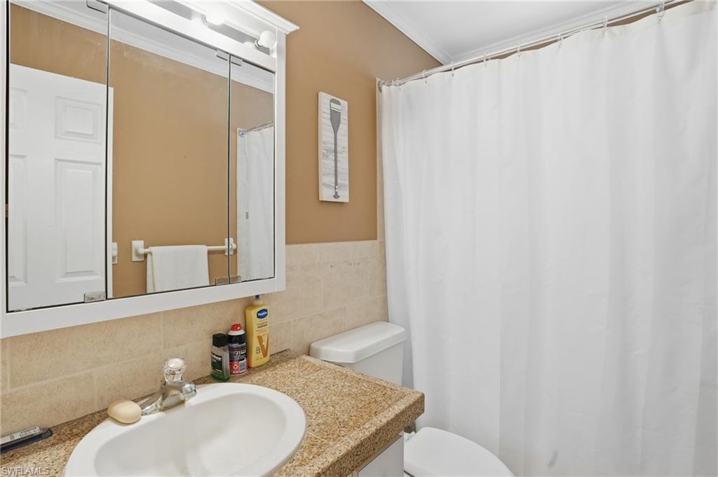 5474 Oak Ridge Avenue Fort Myers Beach, FL 33931 - Photo 36 of 50 a bathroom with a sink toilet and mirror